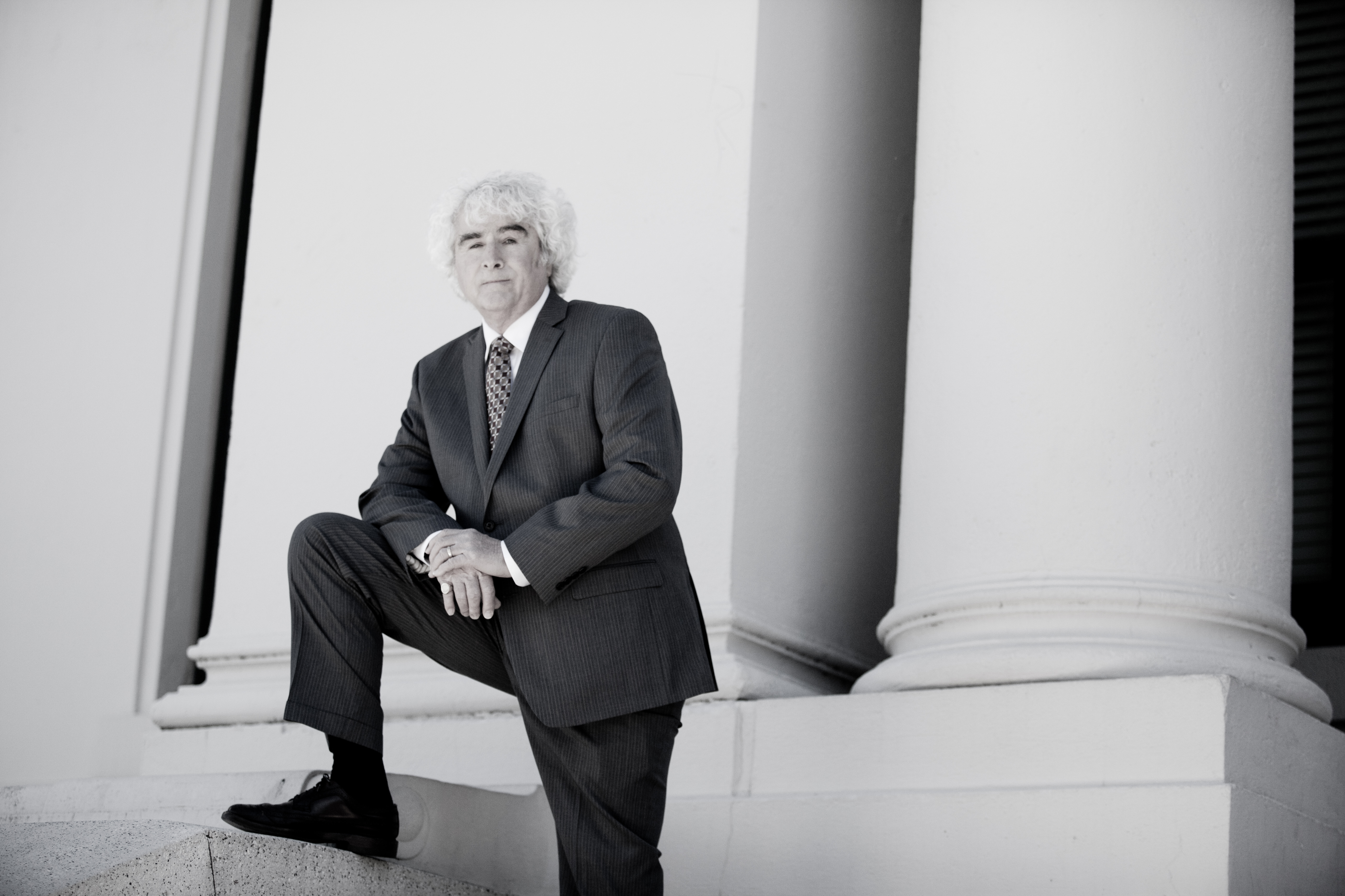 Danny Sheehan seated beside courthouse columns
