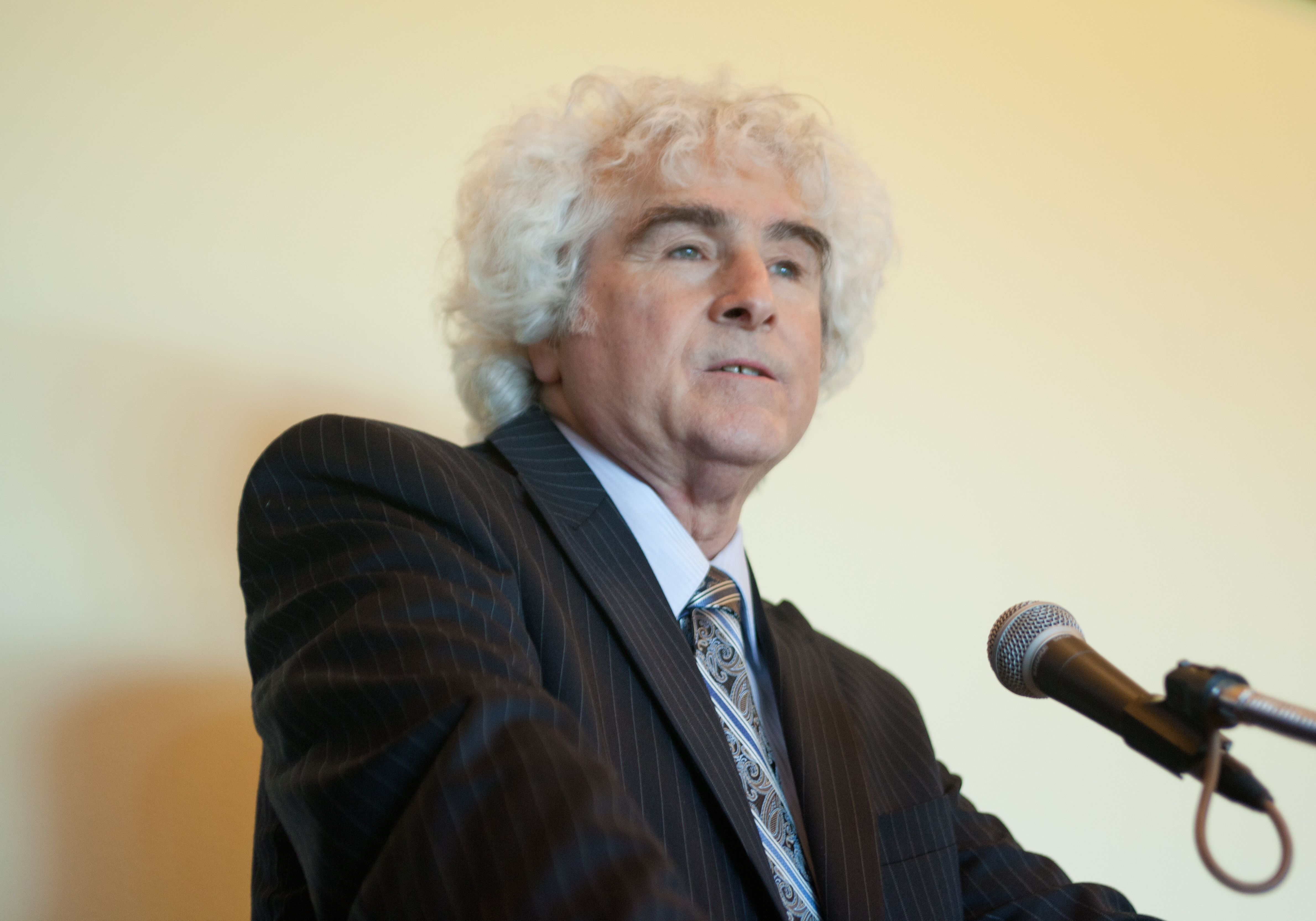 Danny Sheehan speaking at a microphone