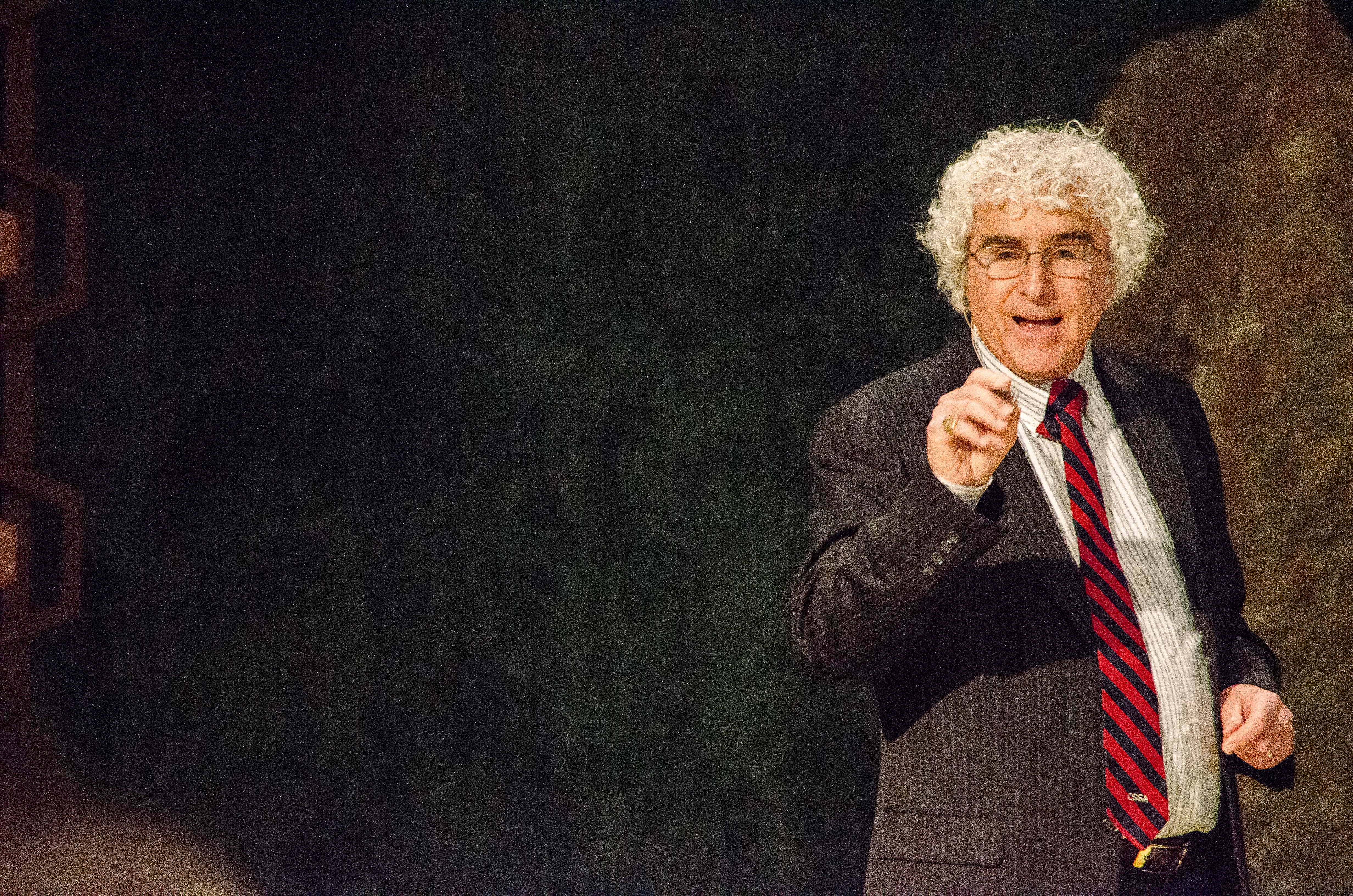 Danny Sheehan speaking on a dark stage